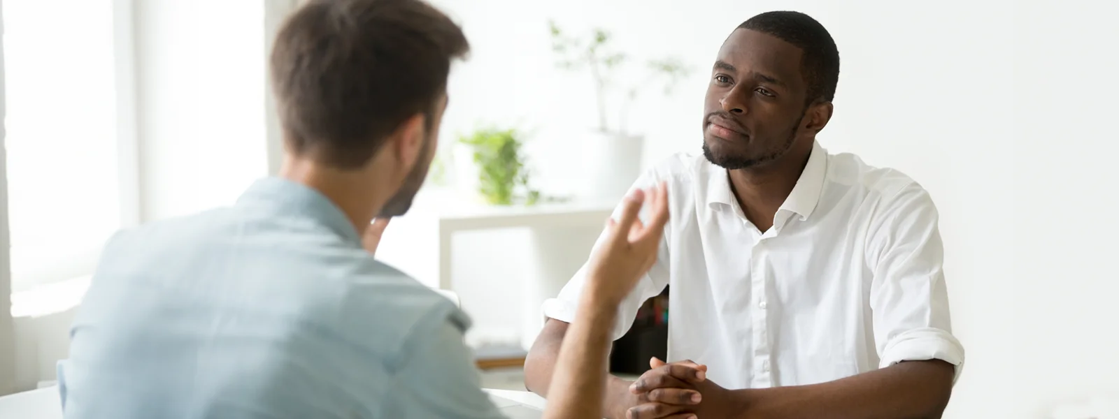 A photo of two men having a conversation