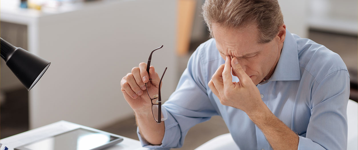 A person is working diligently indoors on their job.