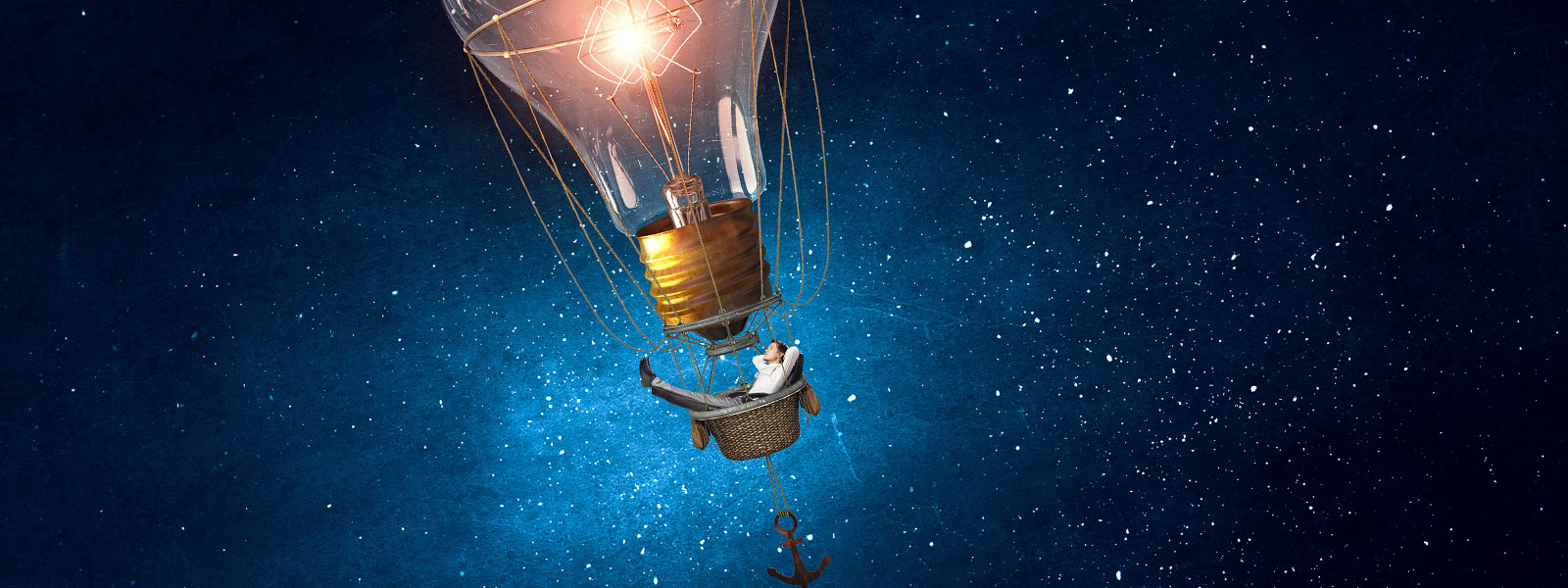 a man floats through the stars in a hot air balloon made of a glowing light bulb