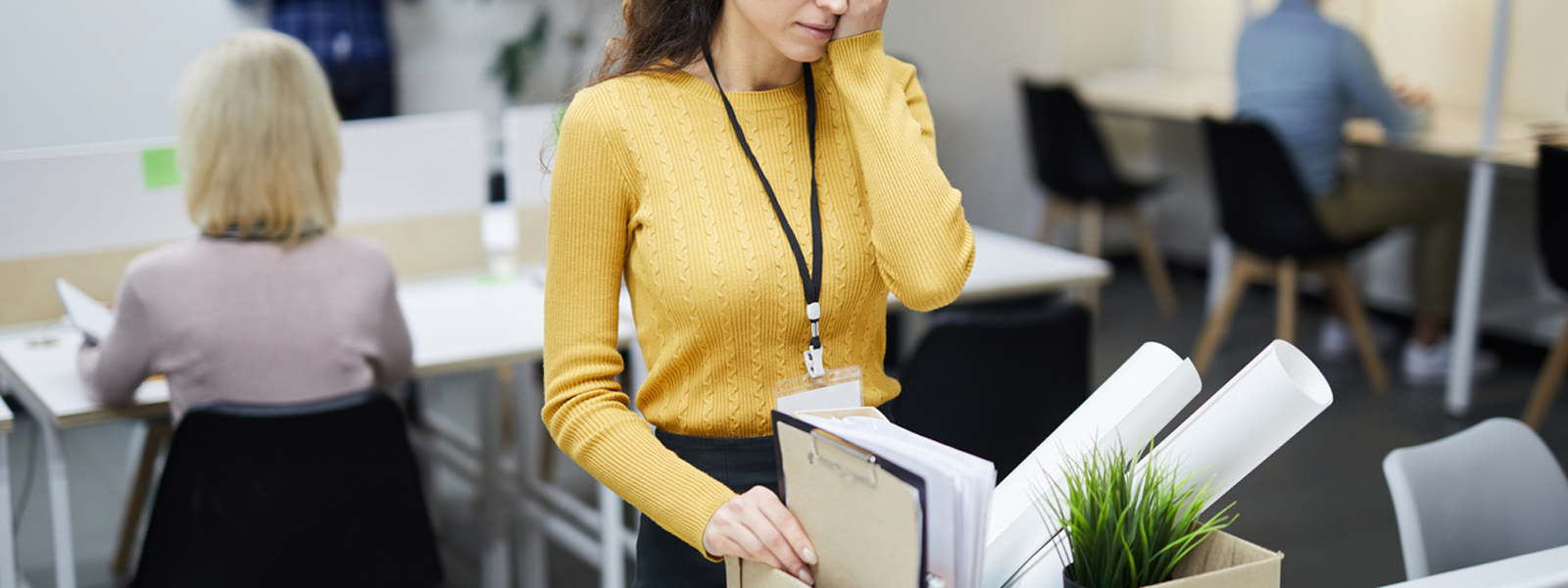 A laid off worker packs her box