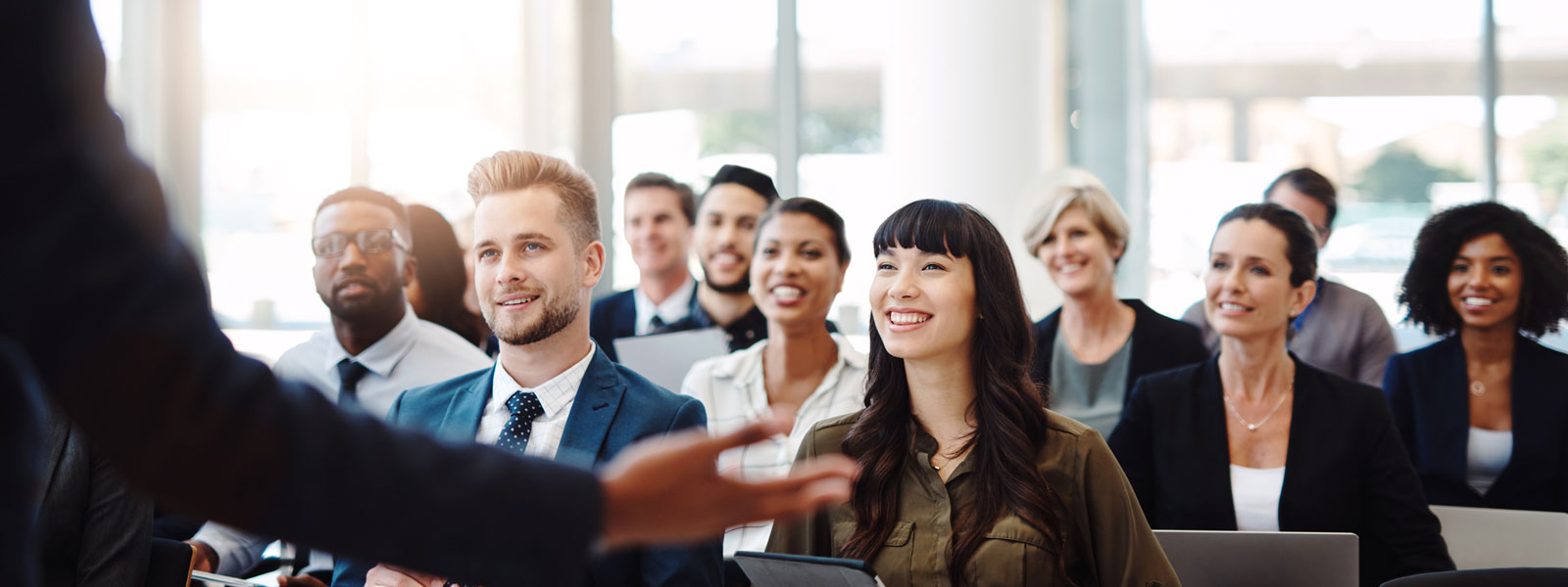 A seminar audience enraptured by a charismatic speaker