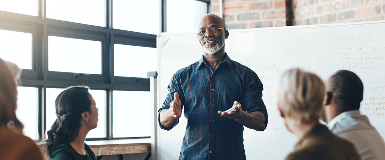 A person stands in front of a whiteboard.