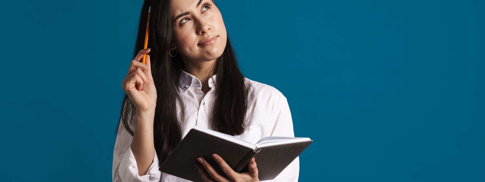 A photo of a young woman debating about adding something to her day planner