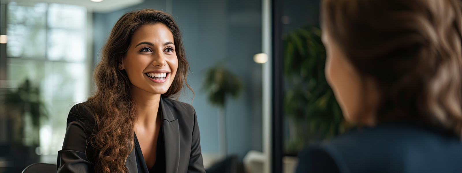 A photo of two women talking in a business setting